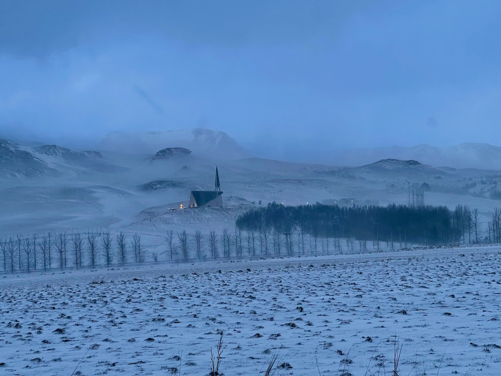 A church in the evening fog of an Icelandic winter